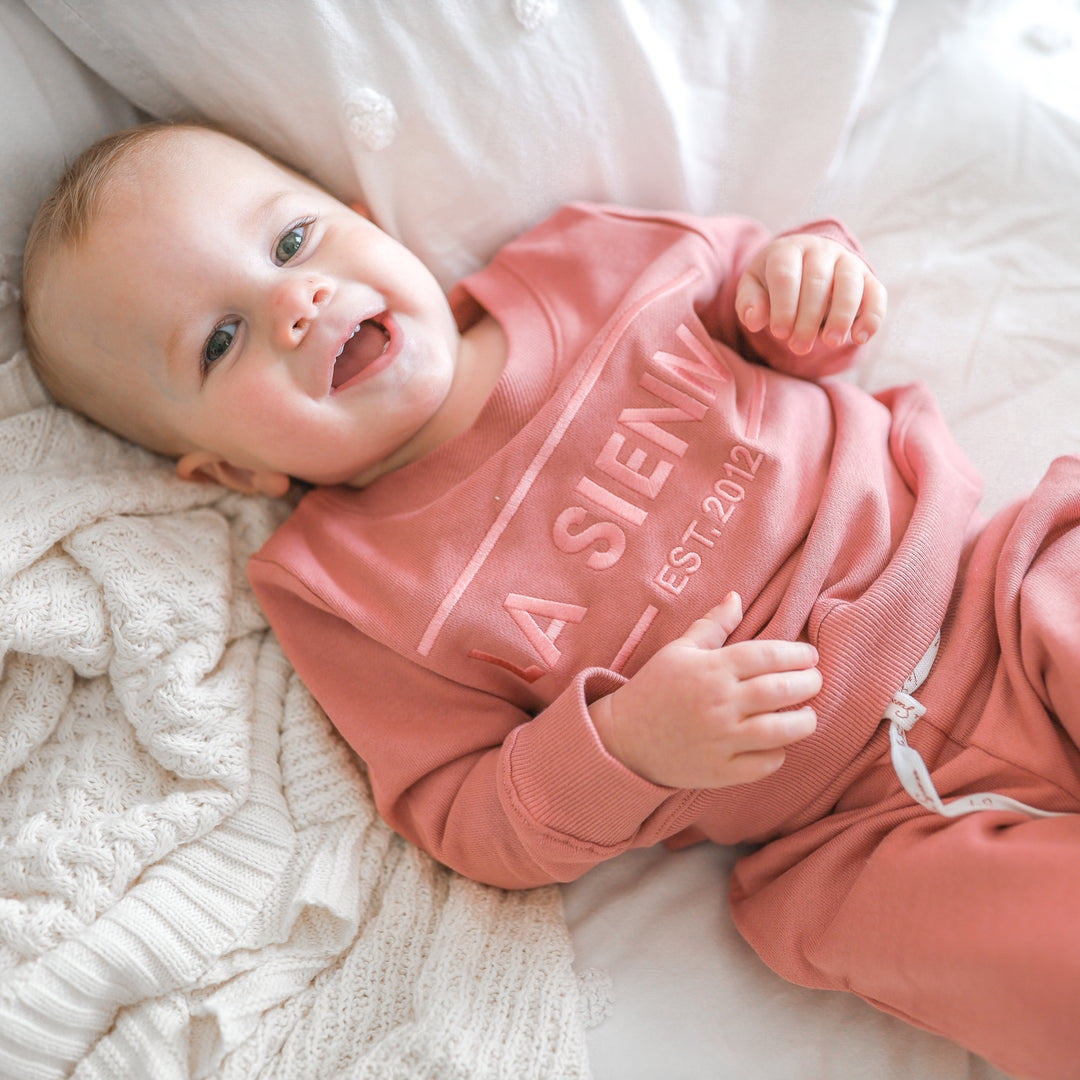 cinder-rose colour baby tracksuit set with logo