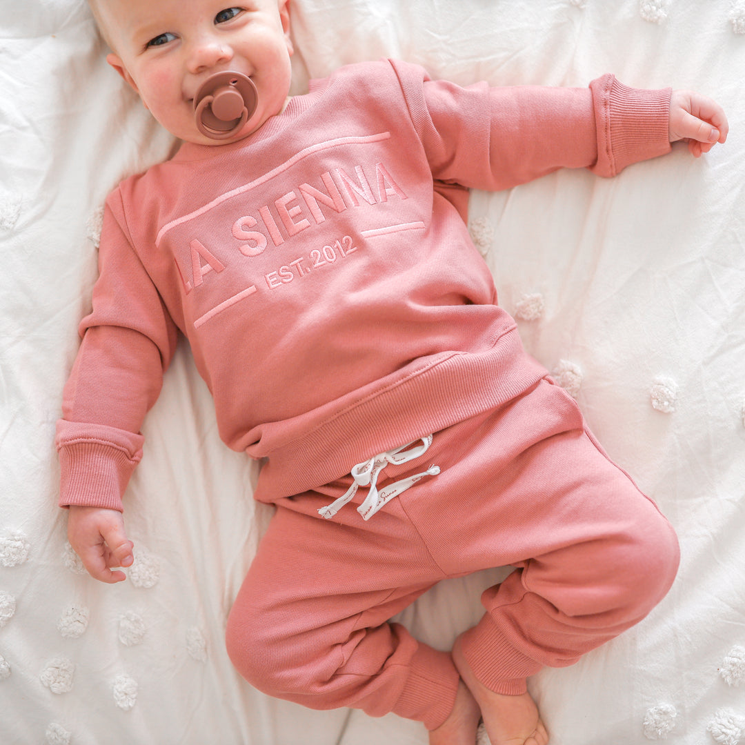 cinder-rose colour baby tracksuit set with logo